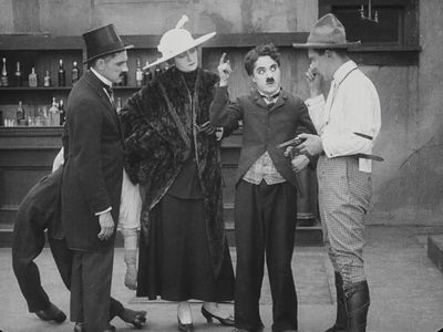 Charles Chaplin and Charlotte Mineau in Behind the Screen (1916)