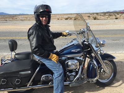 John Prudhont riding his Harley Davidson Road King Classic Motorcycle on a desert highway, near Las Vegas, Nevada.