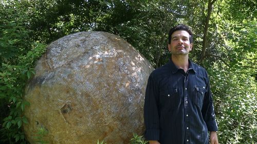 Chris Strompolos stands next to the iconic fake boulder re-made for the Raiders of the Lost Ark adaptation.