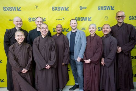 Marc J Francis & Max Pugh surrounded by monks and nuns at SXSW Walk With Me Premiere