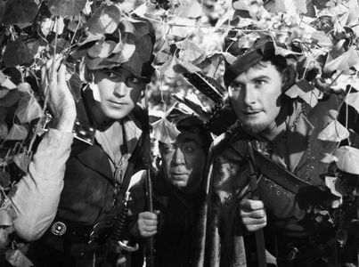 Errol Flynn, Patric Knowles, and Herbert Mundin in The Adventures of Robin Hood (1938)