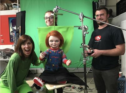 Puppeteers Karyn Malchus, Kyra Gardner, and Bryan Christensen (L to R) prepare the animatronic Chucky for additional pro