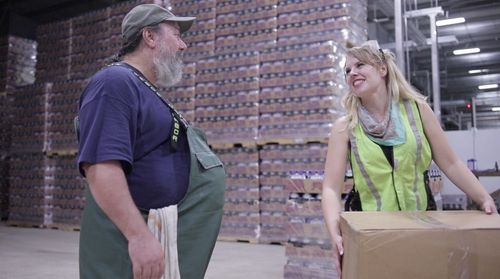 Jerry asks Laura if she needs any help delivering her package, while she politely declines his assistance.