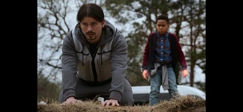 A Still of Ja' Siah Young and Jason Ritter in Raising Dion Season 2.