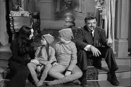 John Astin, Carolyn Jones, Lisa Loring, and Ken Weatherwax in The Addams Family (1964)