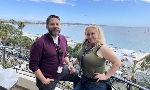Dan Lawler and Lauren Elizabeth Hood in front of the French Riviera at the Cannes Film Festival 2023.