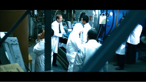 Dr. Greenglass (Allen Enlow) scolds Felix (Alex Kruz) for overlooking the little things as he holds up a filter responsi