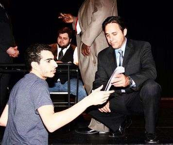 Tom talking over things with director Ramsey Regulus Eassa on the set of 