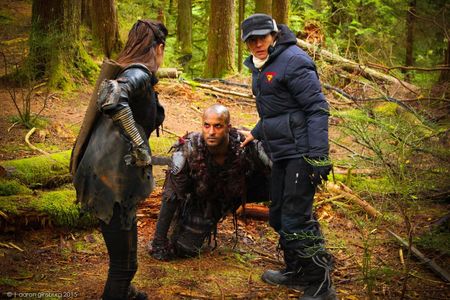 Mairzee ALmas directs Marie Avgeropouos and Ricky Whittle on the set of 