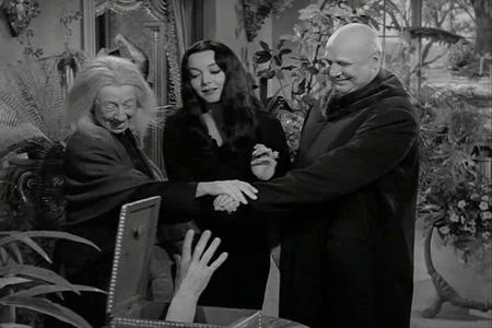 Jackie Coogan, Marie Blake, Carolyn Jones, and Thing in The Addams Family (1964)