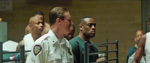 Screen Shot from the 2019 Movie 'The Informer'. Kenny-Lee Mbanefo playing the role of an Prison Inmate staring down Pete