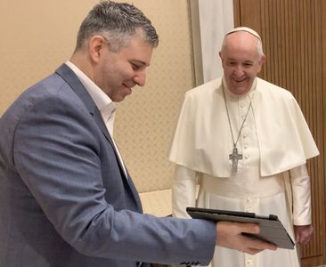 Director Evgeny Afineevsky, showing parts of the movie to Pope Francis