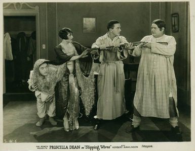 Oliver Hardy, Albert Conti, Priscilla Dean, and Stan Laurel in Slipping Wives (1927)