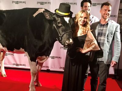 Kimberley Crossman, Nick Greco and Ryan Churchill pose with their co-star Reaction the cow at The 60 Yard Line premiere 