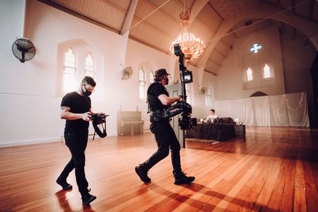 Cinematographer Anthony Littlechild watches the shot behind Steadicam Operator Aaron Foley on set for Liam Ferrari 