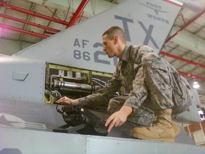 James Burleson is performing a nondestructive inspection testing method on the exterior of an F-16.