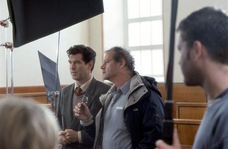 PIERCE BROSNAN discusses a scene with director BRUCE BERESFORD on the set.
