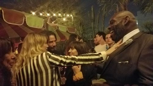 Suki Waterhouse, Keanu Reeves and Ana Lily Amirpour discussing Cory Roberts feathered bowtie at The Bad Batch LA premier