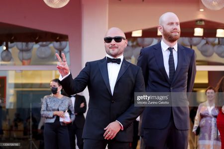 VENICE, ITALY - SEPTEMBER 11: (R) Lucas Engel and (L) Adam Butterfield attend the closing ceremony red carpet during the