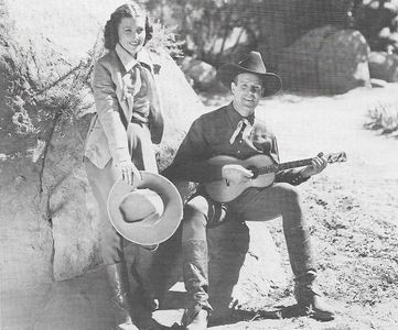 Mary Hayes and Kermit Maynard in Roaring Six Guns (1937)