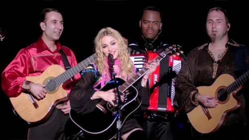 Madonna, Kevin Antunes, Vadim Kolpakov, and Brian Frasier-Moore in Madonna: Sticky & Sweet Tour (2010)