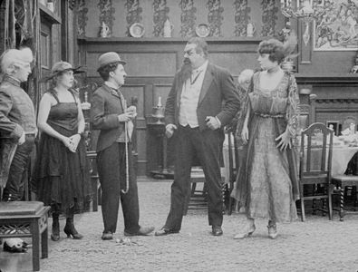 Charles Chaplin, Eric Campbell, Charlotte Mineau, and Edna Purviance in The Count (1916)