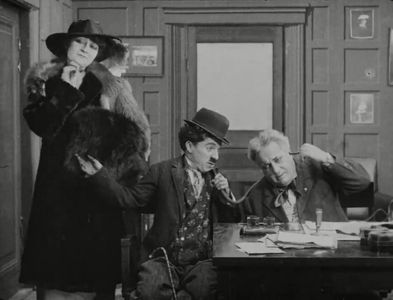 Charles Chaplin, Robert Bolder, and Charlotte Mineau in His New Job (1915)