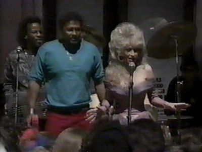 Dolly Parton, Aaron Neville, and The Neville Brothers in Dolly (1987)