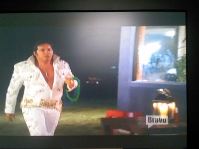 Dean Ciallella as Elvis, entering the outdoor dining area on the set of Bravo Television's Real Housewives of New York C