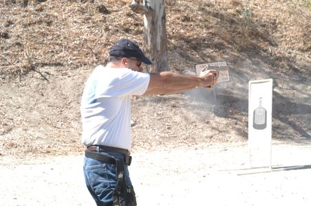James D. Dever at the pistol range firing his 1911 Colt commander