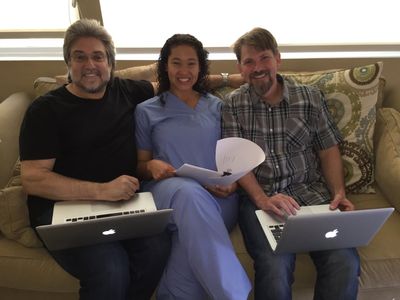 Writing partners, Greg P. Russell & Rob Rose check the medical accuracy of a script with medical consultant, Andrea Read