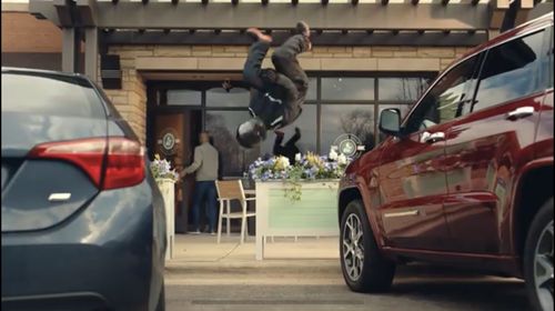 Quentin Sanders Performing a side flip over a rack of flowers in the WeatherTech Coffee Run Commercial