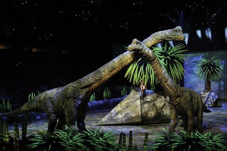 Still shot of Mama & baby Brachiosaurus with JB, Walking With Dinosaurs, Madison Square Garden.