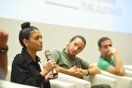 Elghety speaking in a panel discussion on 