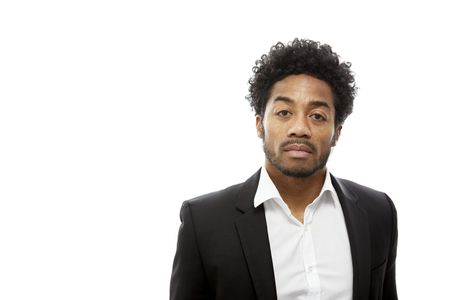 man-with-cool-afro-hairstyle-wearing-black-suit-white-shirt