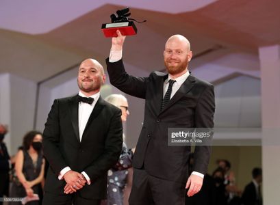 VENICE, ITALY - SEPTEMBER 11: Lucas Engel (R) and Adam Butterfield (L) pose with Orizzonti Award for the Best Short Film