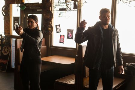 Kellan Lutz and Gina Carano in Extraction (2015)