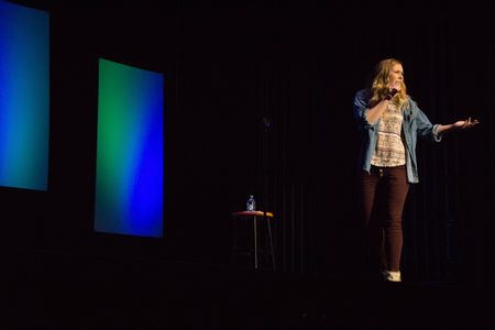 Rebecca performing stand up comedy at Elon University