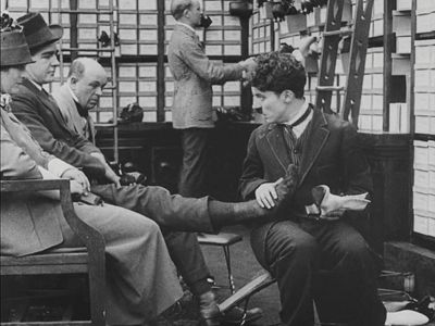 Charles Chaplin, Fred Goodwins, and Tom Nelson in The Floorwalker (1916)