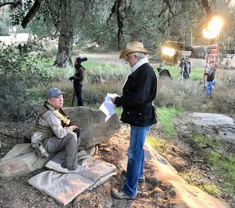 McKay Daines going over a scene with Graham Greene on the set of Shadow Wolves