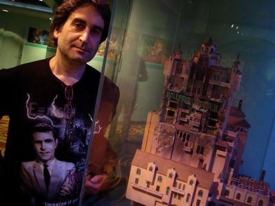 Mark Silverman standing by a miniature of the popular Disney attraction 