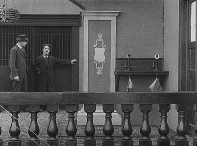 Charles Chaplin and Tom Nelson in The Floorwalker (1916)