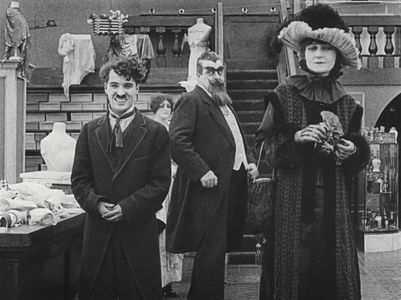 Charles Chaplin, Eric Campbell, and Charlotte Mineau in The Floorwalker (1916)