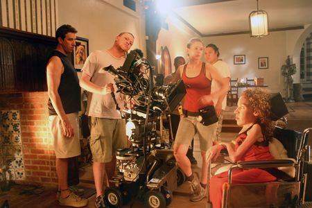 Directors Jackie Julio and Doug Olear set up a shot with camera operator, Kit Pennebaker, and crew on the set of the awa