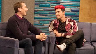 Episode 7 Joe Jonas Wears a Maroon and Gold Letterman Jacket with White Sneakers